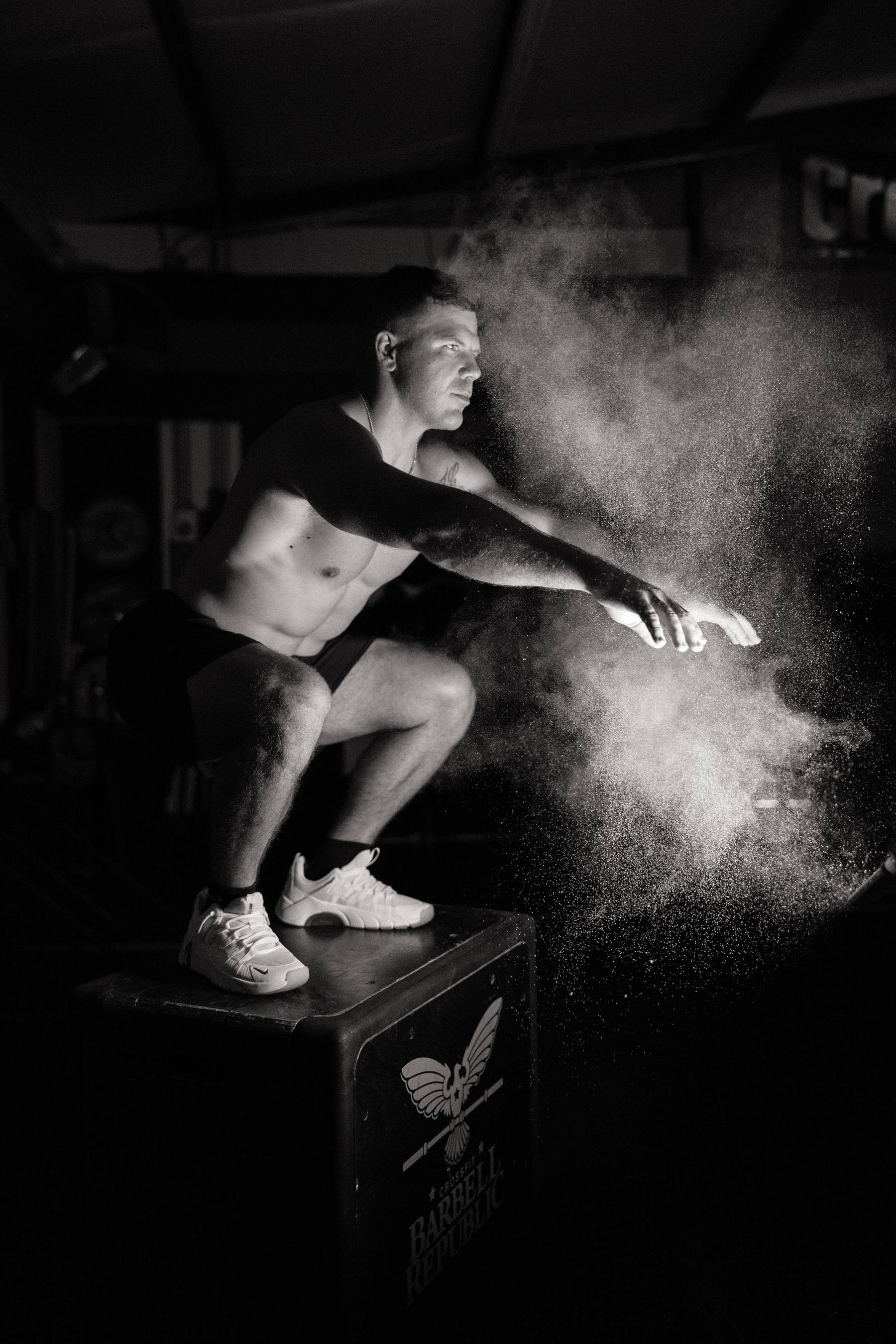 Athlete on a CrossFit Barbell Republic plyo box in a cloud of chalk