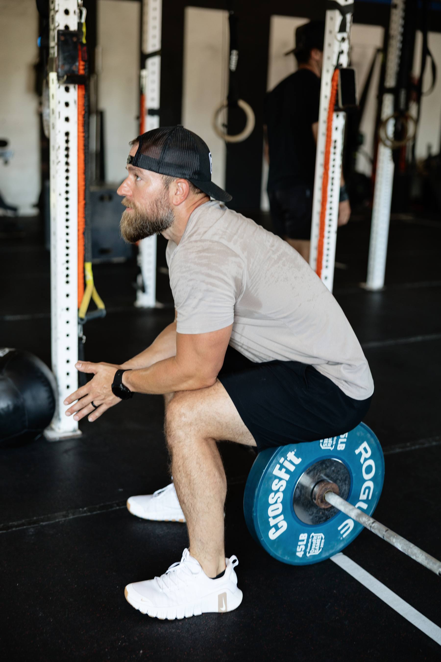 A coach talking an athlete through a lift
