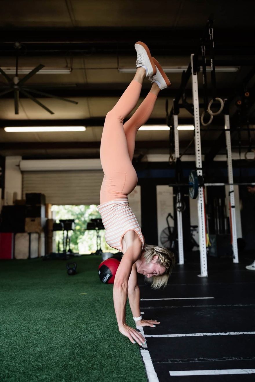 Coach Chantel Arnold holding a handstand