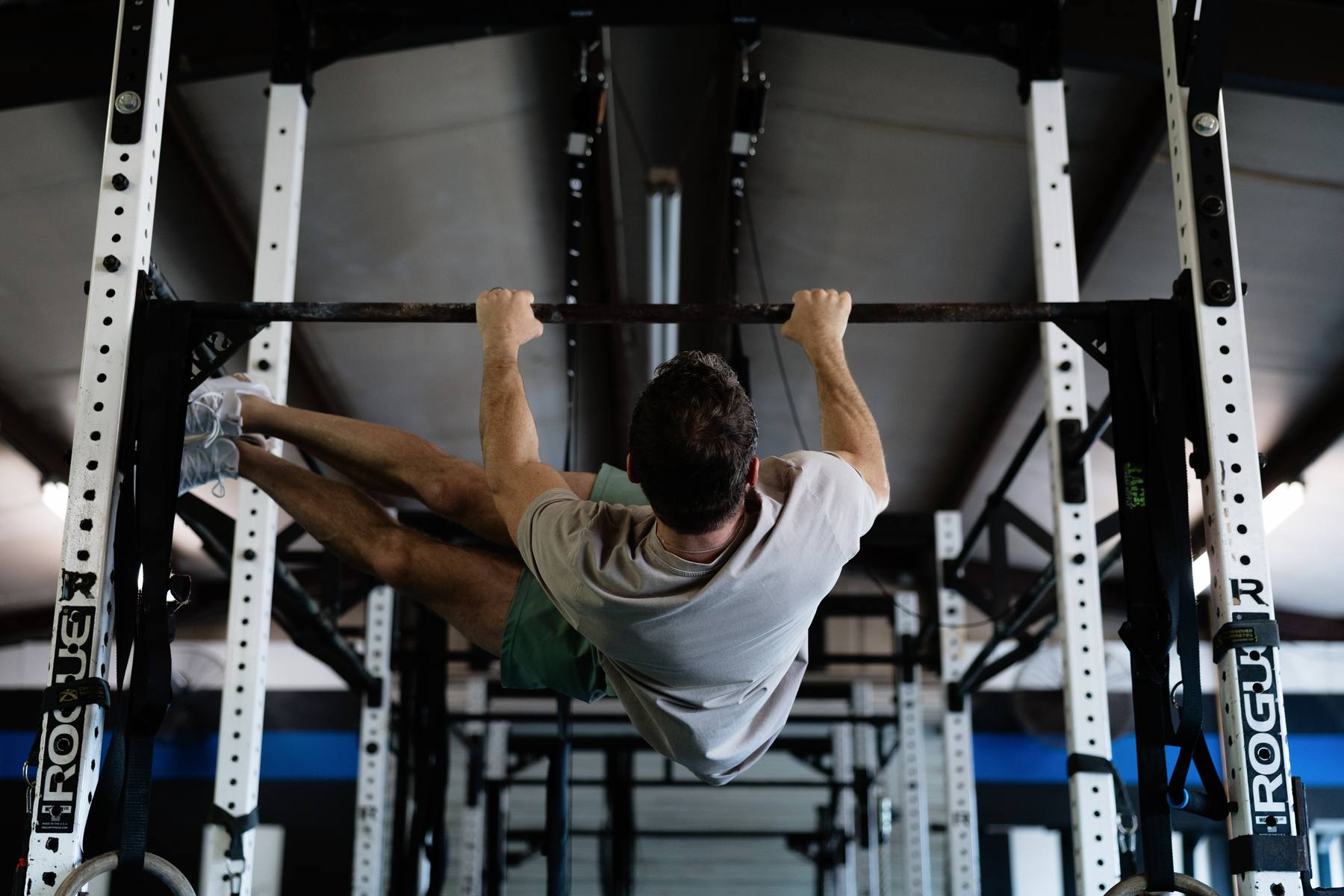 Athlete hanging from the pull-up bar during toes-to-bar